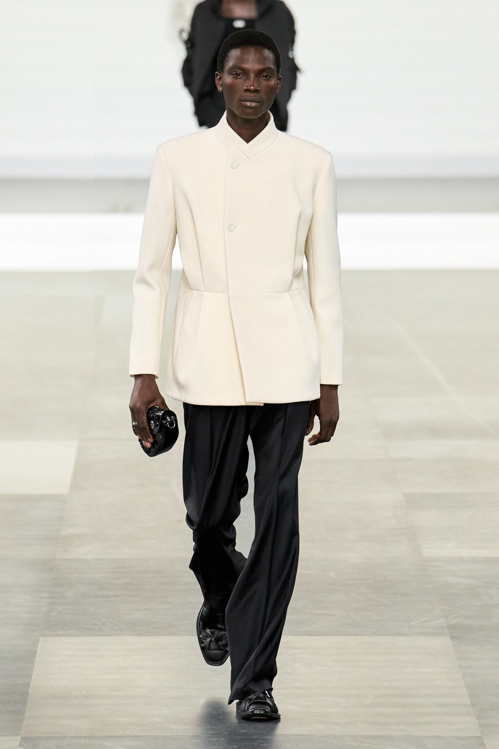 Images may contain Aamito Lagum outfit formally wearing suit staff standing adult walking jacket and shoes