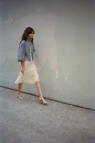 Image may contain clothing sleeves for a teenager footwear high heels skirt and jacket