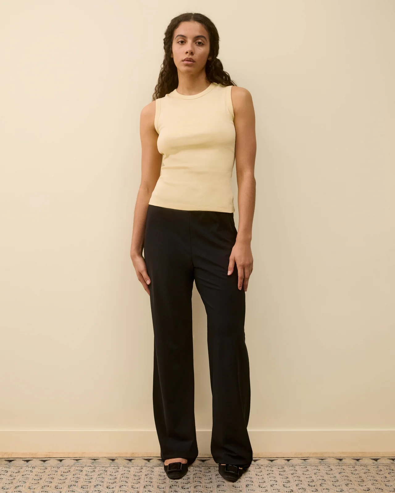 Image may contain clothes and pants standing adult shirt and formal wear