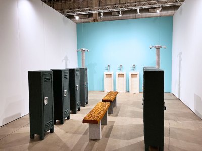 A view of an art installation that depicts a locker room with the many pieces covered in crochet.