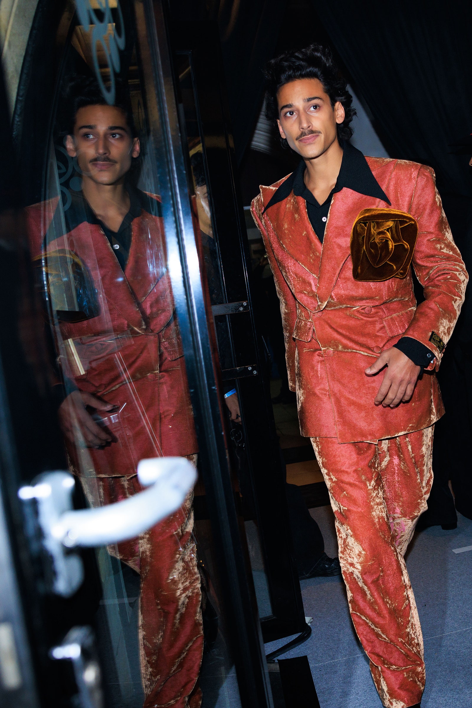 Images may contain tiger shroft tiger shroff velvet clothing jacket fashionable adult and formal wear