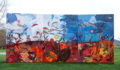 The large standing magazine depicts a landscape with orange and red autumn grounds and large blue sky.