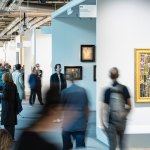 A crowded art fair viewpoint, with several people blurring.