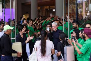 Apple CEO Tim Cook and Deirdre O'Brien, senior vice president of Apple retail, greet people at the inauguration ceremony of the first Apple retail store in Mumbai