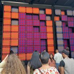 People stared at a 25-foot-tall installation made of braided squares of red, blue and gold.