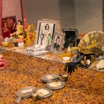 Details of the altar installation, which has mirror images, photos of Dolores del Rio, fans, rose petals, pink satin fabrics, and more.