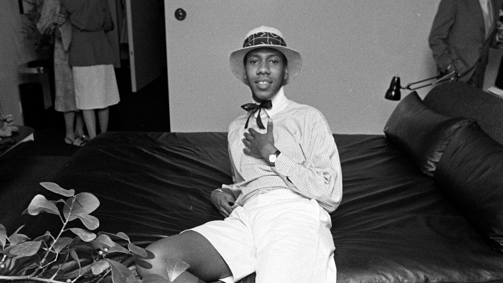 Images may contain Andr Leon Talley Couch furniture watch hat hat plant pot plant and face