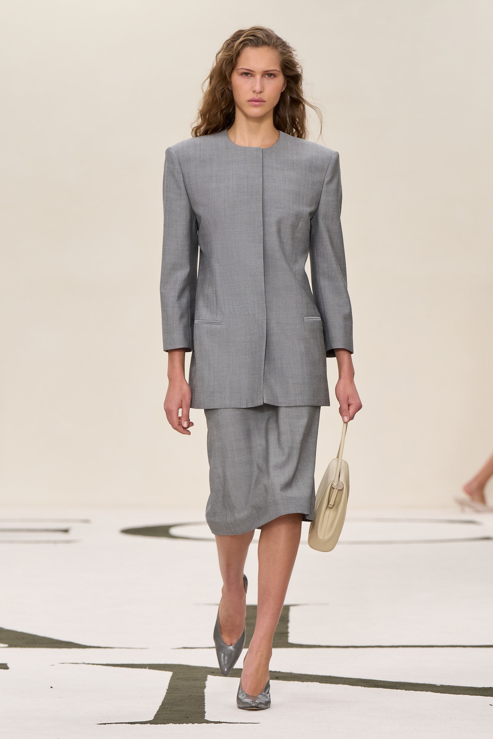 Images may contain clothing formally wearing suit dress shoes adult adult high heel skirt accessories and bags