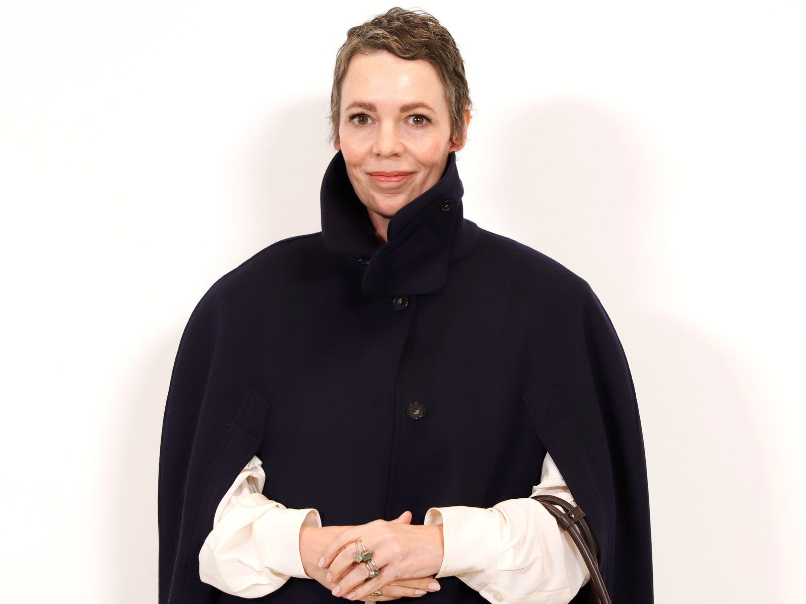 Images may contain Olivia Colman adult accessories jewelry ring face photography portrait and fashion