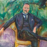 A man's painting on a chair.