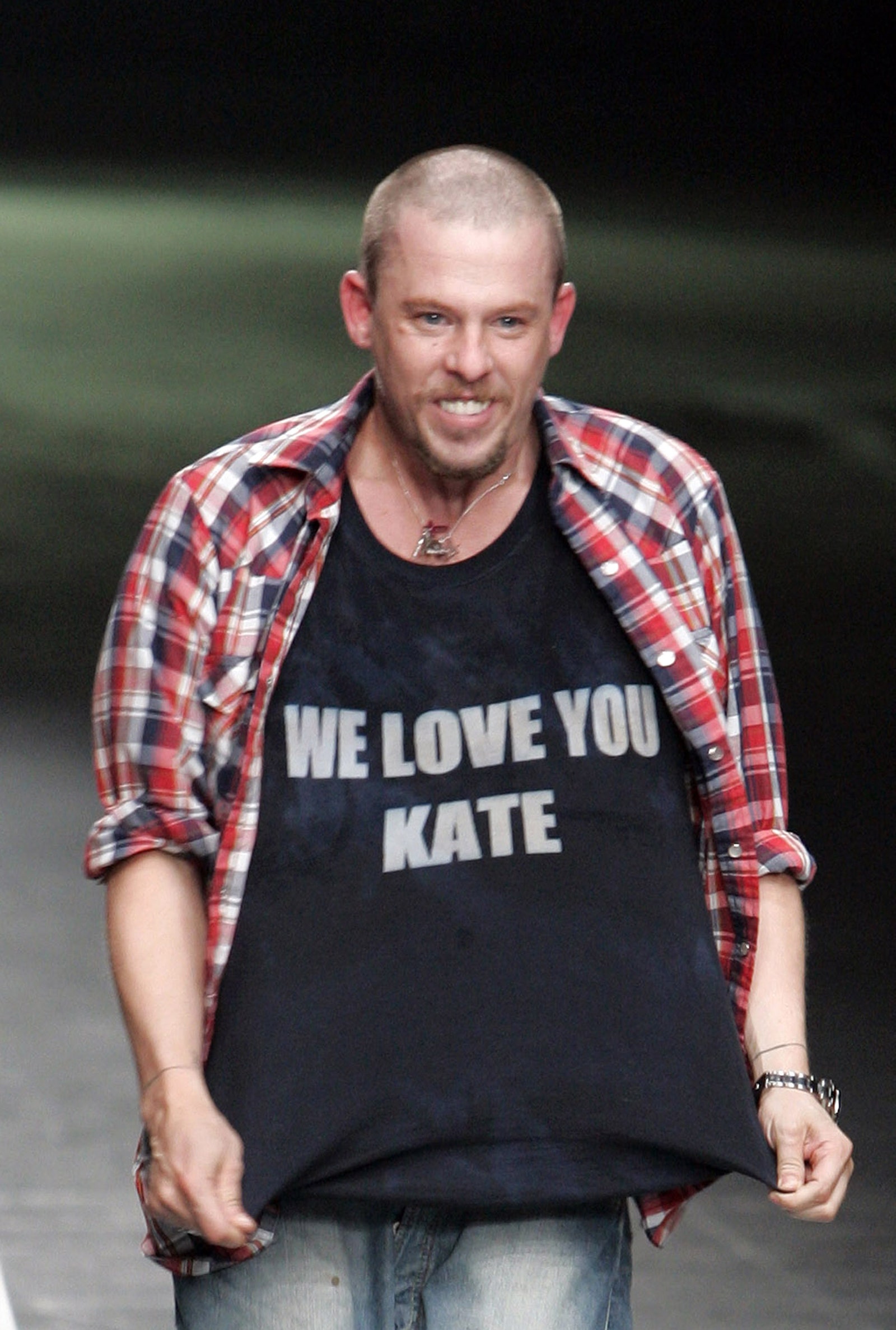 Images may contain Alexander McQueen clothing T-shirt facial man photography portrait pants adult and shirt