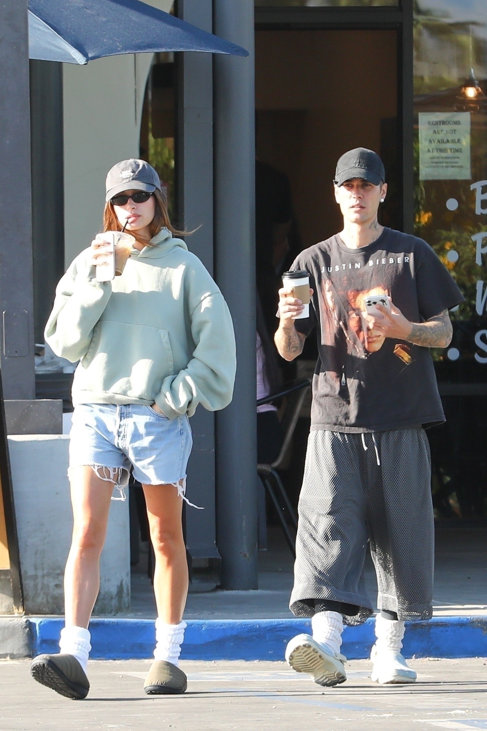 Images may contain Margareth Madèustin Bieber clothing shorts baseball cap hat shoes shoes and teenagers