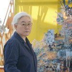 In the studio in front of the sculpture, a portrait of artist Lee Bul.