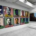 A gallery whose walls are filled with Mao Zedong's screen printed portraits, with various colors on them.