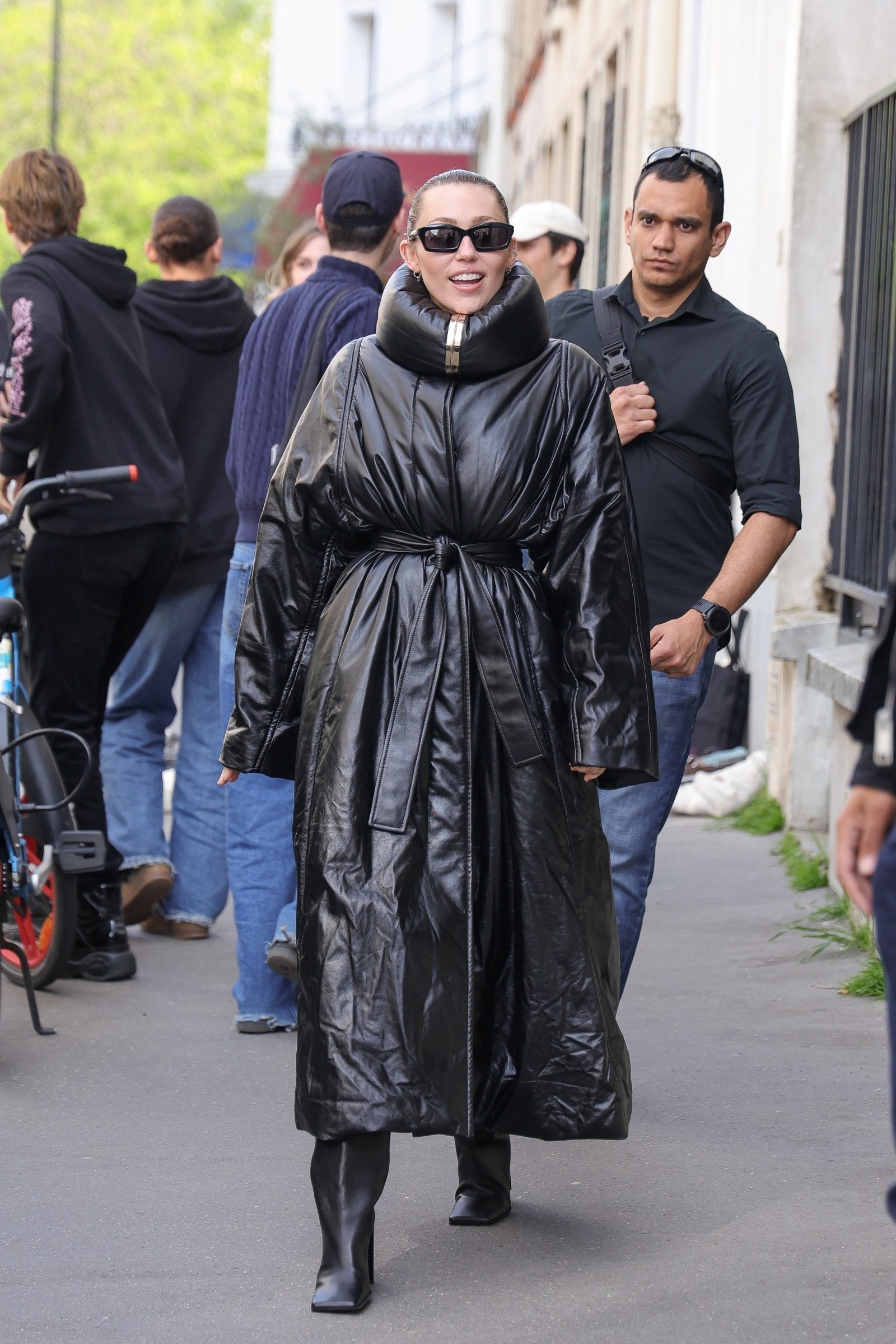 Images may contain Miley Cyrus Clothing Jacket Accessories Glasses Wrist Hat Adult Shoes Shoes & Bags
