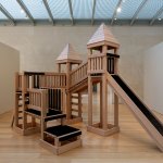 A playground castle for kids with red oak wood was rebuilt, with all sidewalks and slides covered with wild hair.