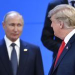 Two men in suits looked at each other.