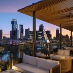 The Austin skyline can be seen from the hotel rooftops.