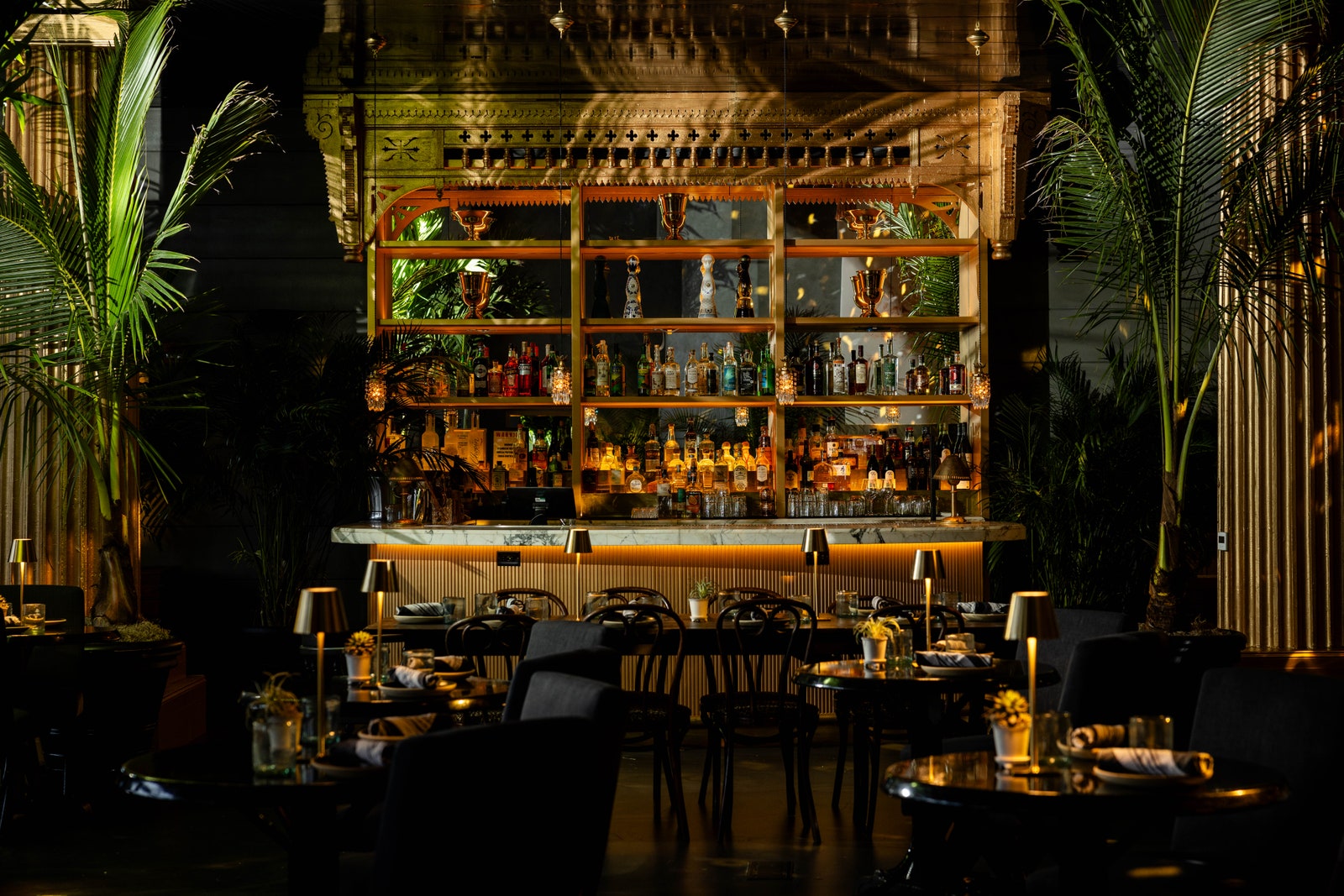 Images may contain bar chair furniture cup lights and city
