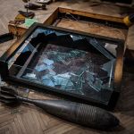 Broken glass boxes in the looted Helsen Regional Museum during Russian invasion of Ukraine, 2022.