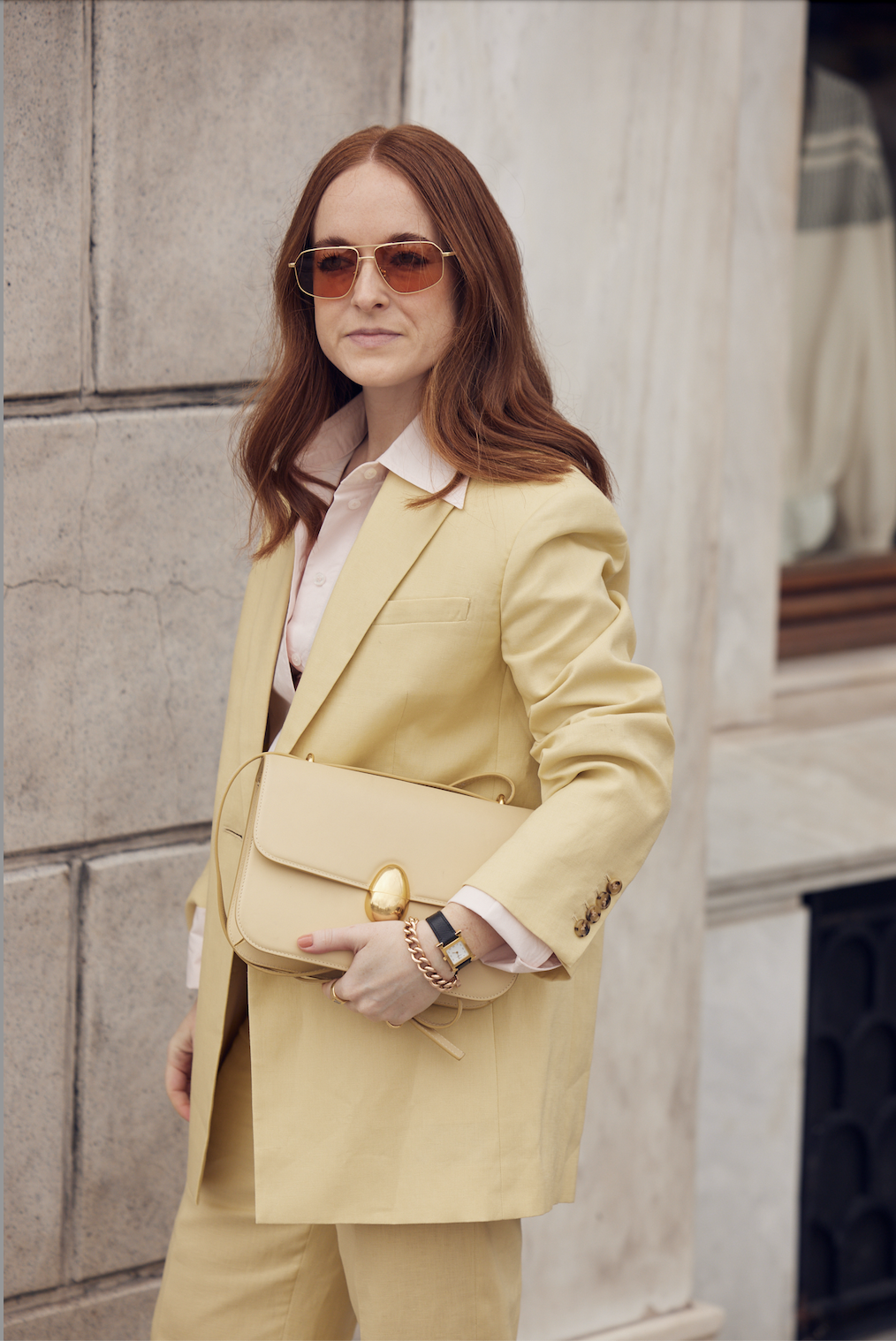 Images may contain clothing jacket coat coat adult formal wear accessories handbags and face