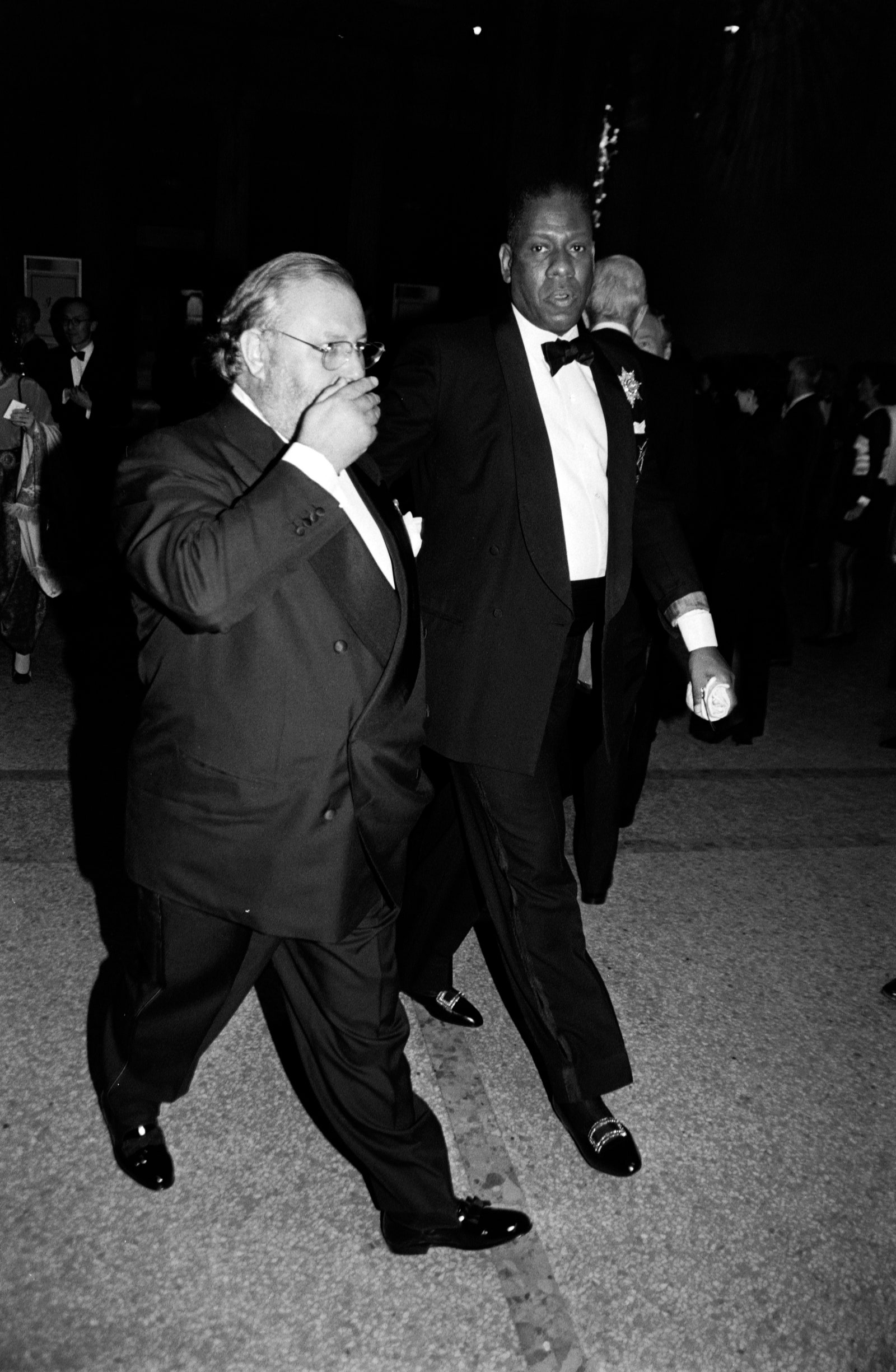 Images may contain Gianfranco Ferr Andr Leon Talley outfit formally wearing suit tuxedo jacket and walking