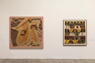 Two wall-mounted weaves, one of which is characterized by a female image, situated on a star.