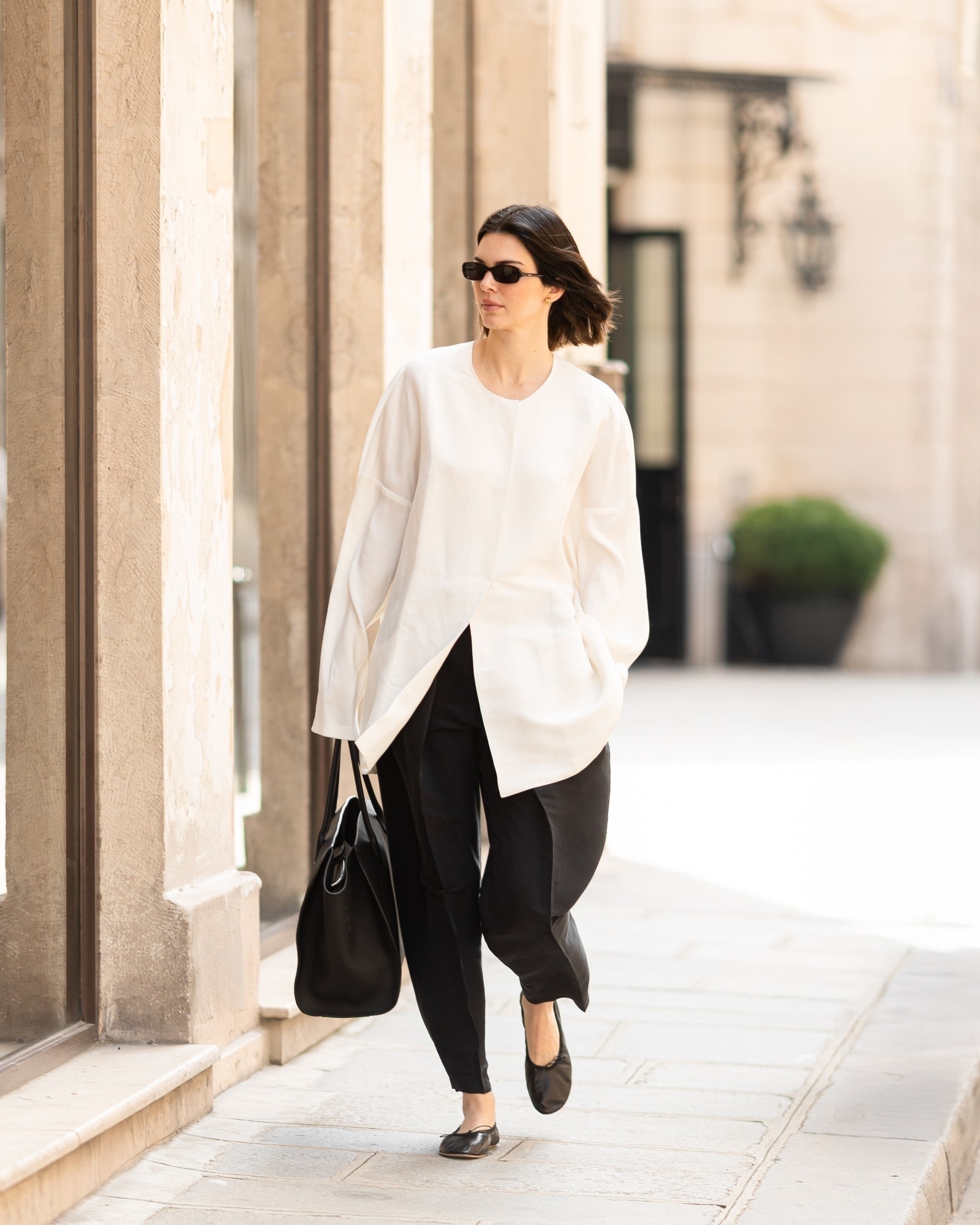Images may contain Kendall Jenner shirt clothing pants shoes adult long-sleeved sleeves and blazer