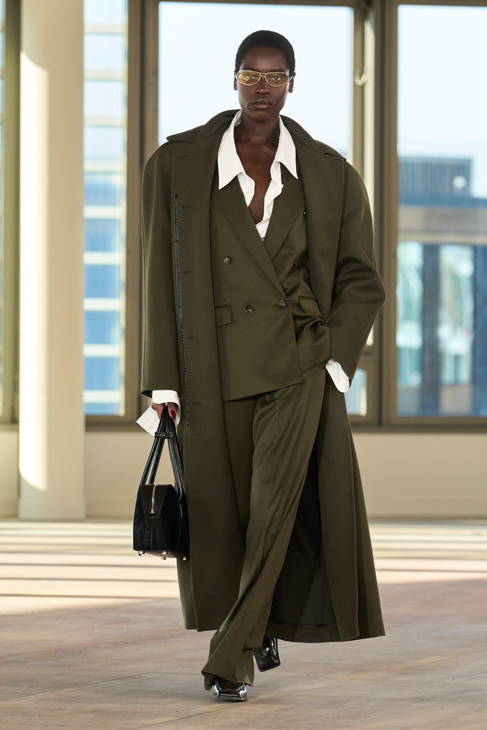 Images may contain clothing jacket accessories glass bag handbag coat personnel footwear and shoes