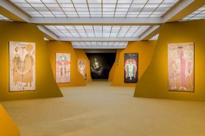 The museum exhibition is installed in the landscape, showing large paintings on the walls painted by cadmium. 