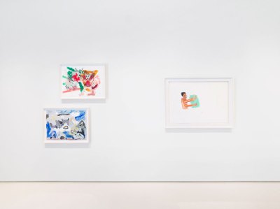 View of the gallery wall shows three works on paper. 