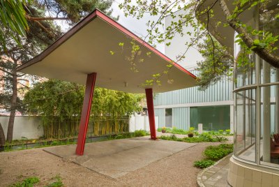 An outdoor red canopy with two tilted support. 