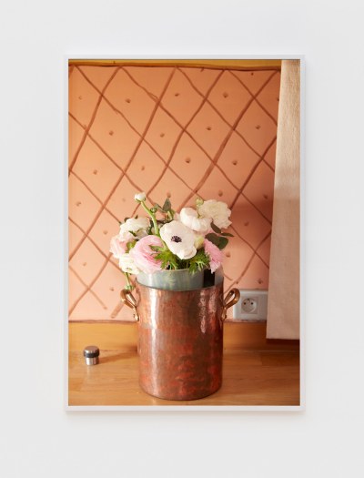 Photo of white and pink roses in a bouquet of copper buckets. 