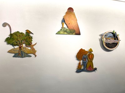 Four cuts were hung on the wall. They showcase various surreal scenes.