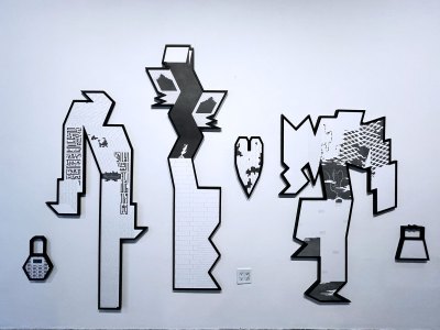 There are four paper-shaped works on paper. They are drawings of black and gray graphite.