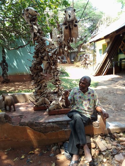 One person sat next to a sculpture made of various bone fragments. 