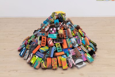 A sculpture made of a collection of painted bricks. 