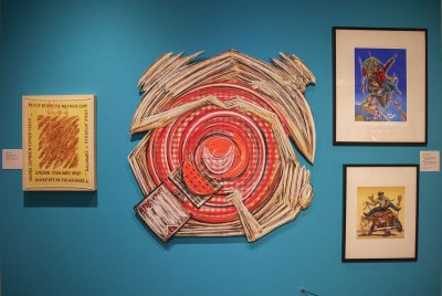 View of a museum exhibition with an work of a swirling kitchen table.