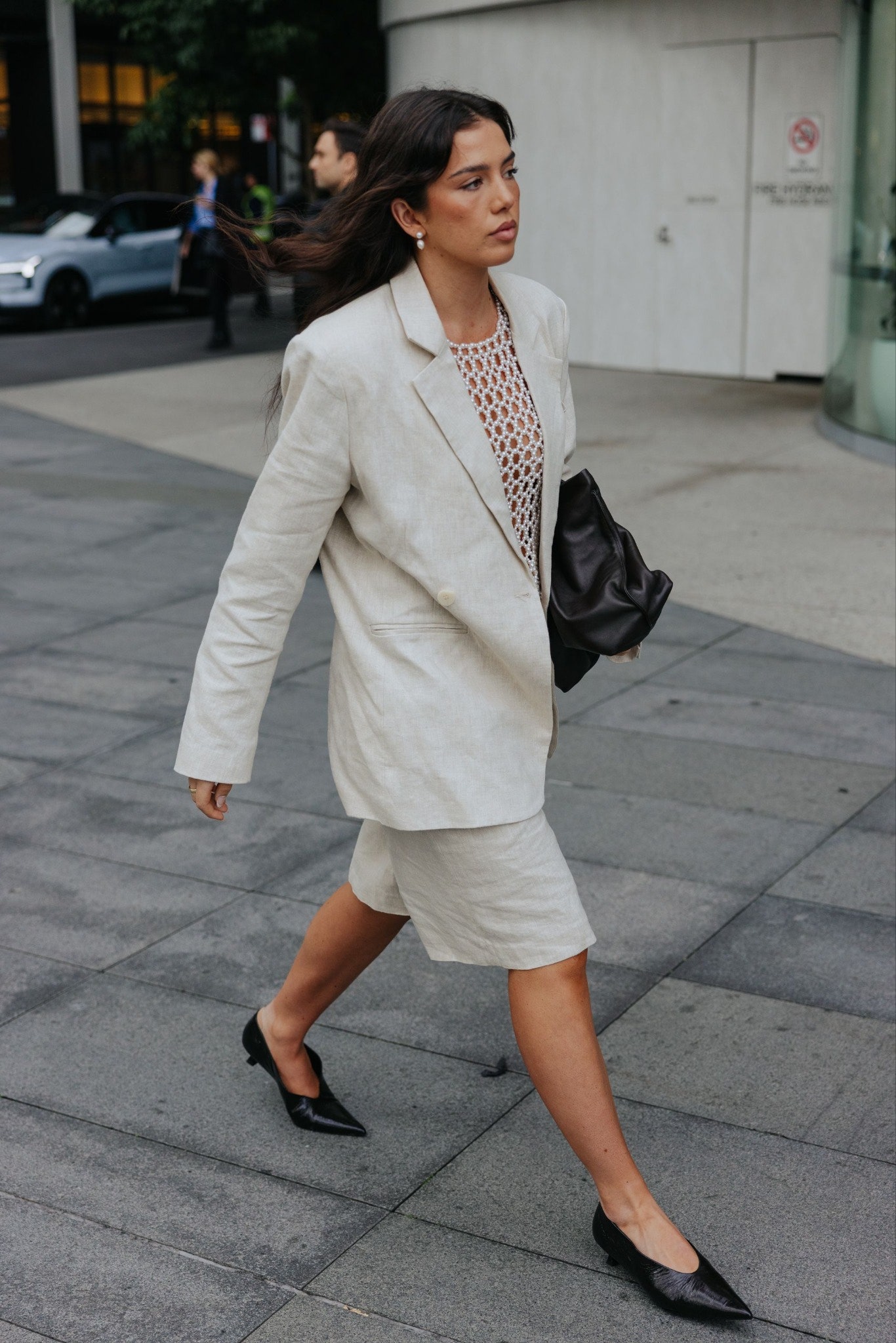Images may contain clothing formal clothing staff blazer jacket high heels accessories and bags