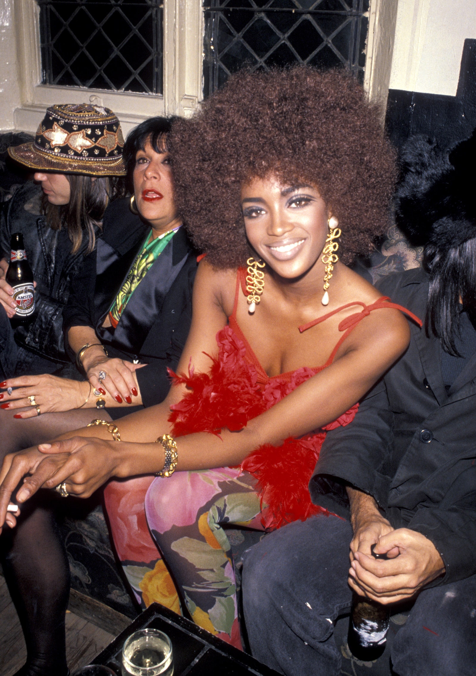 Image may contain adult accessories for Naomi Campbell clothing caps Jewelry ring cup bracelet face and head
