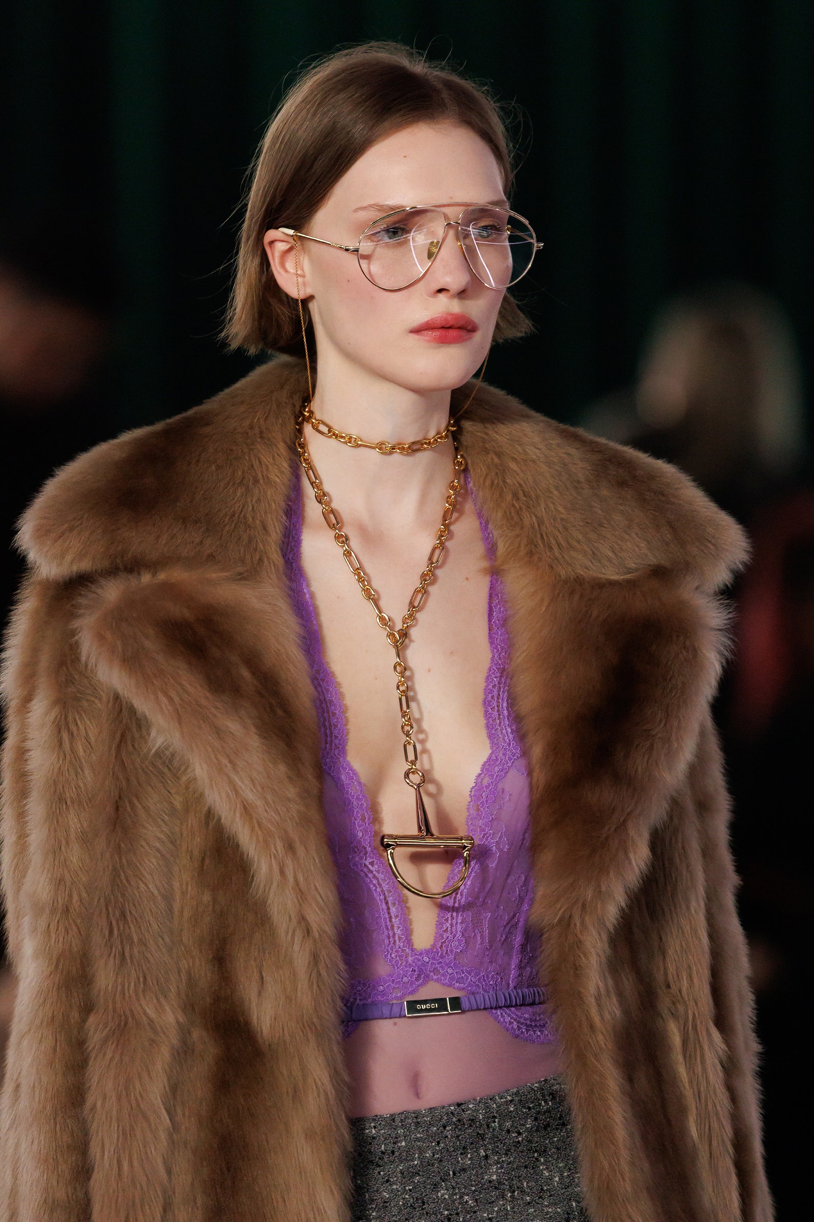 Images may contain clothing jacket glass jewelry necklace adult and fur