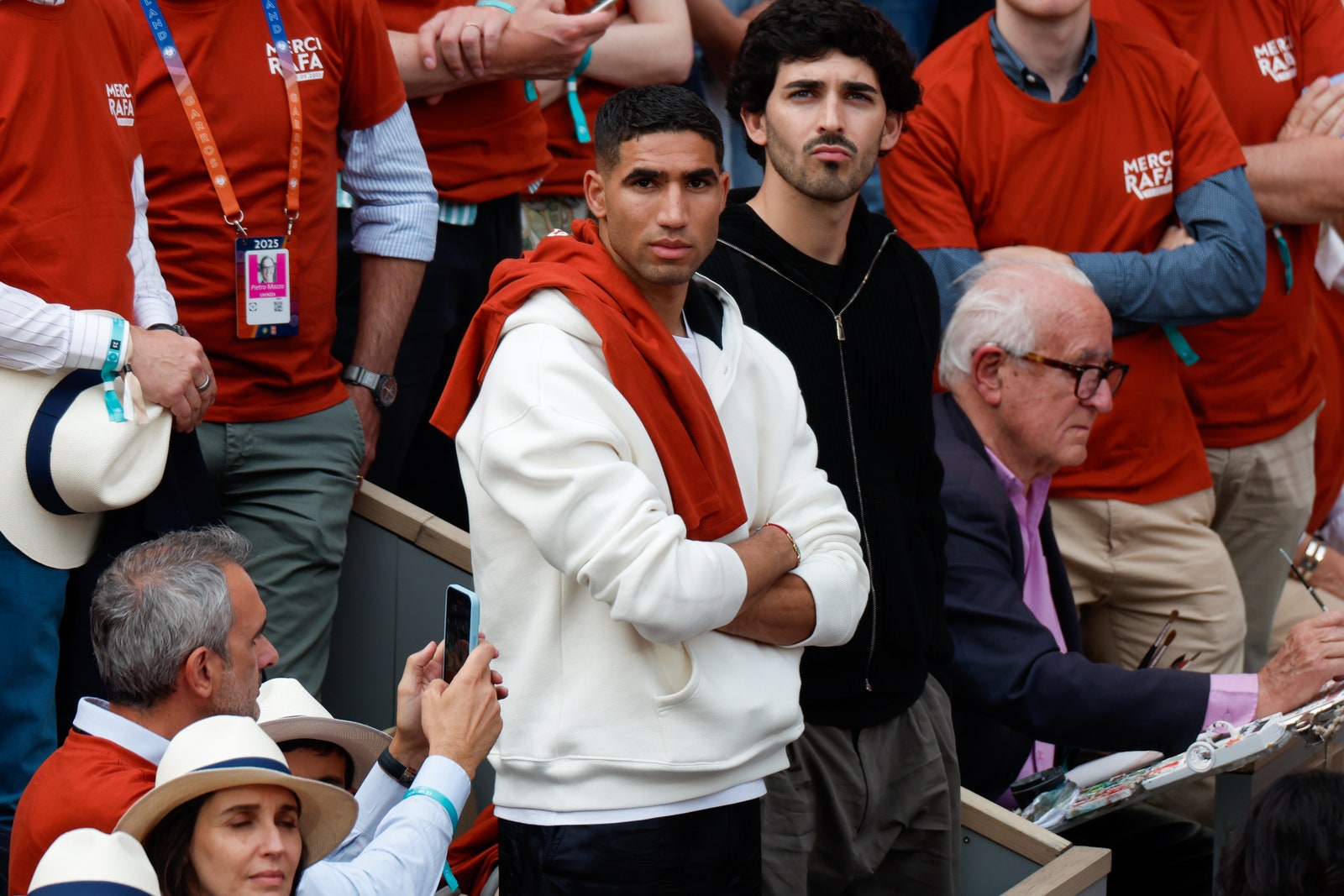 Images may contain Mehdi Brando Mahdloo Achraf Hakimi Alan Yentob people's cell phone and phone