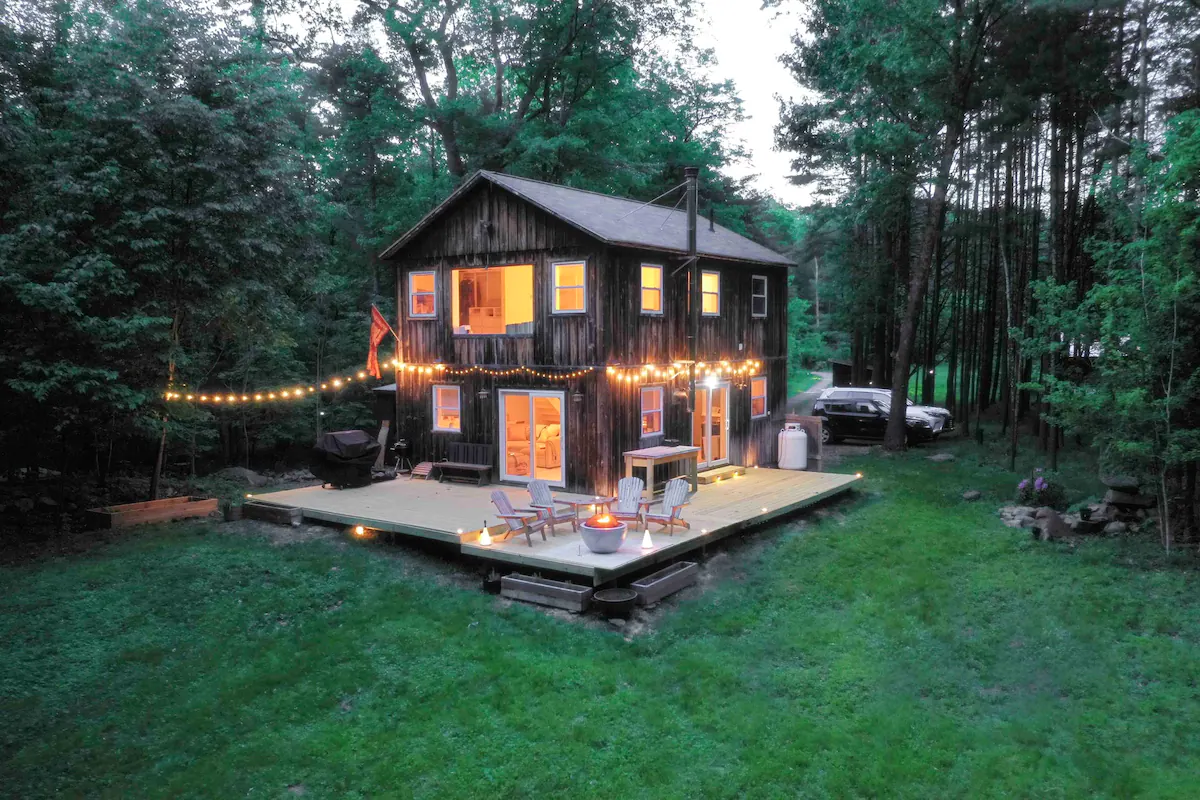 Image may contain building building housing house hut in woods chair furniture and car
