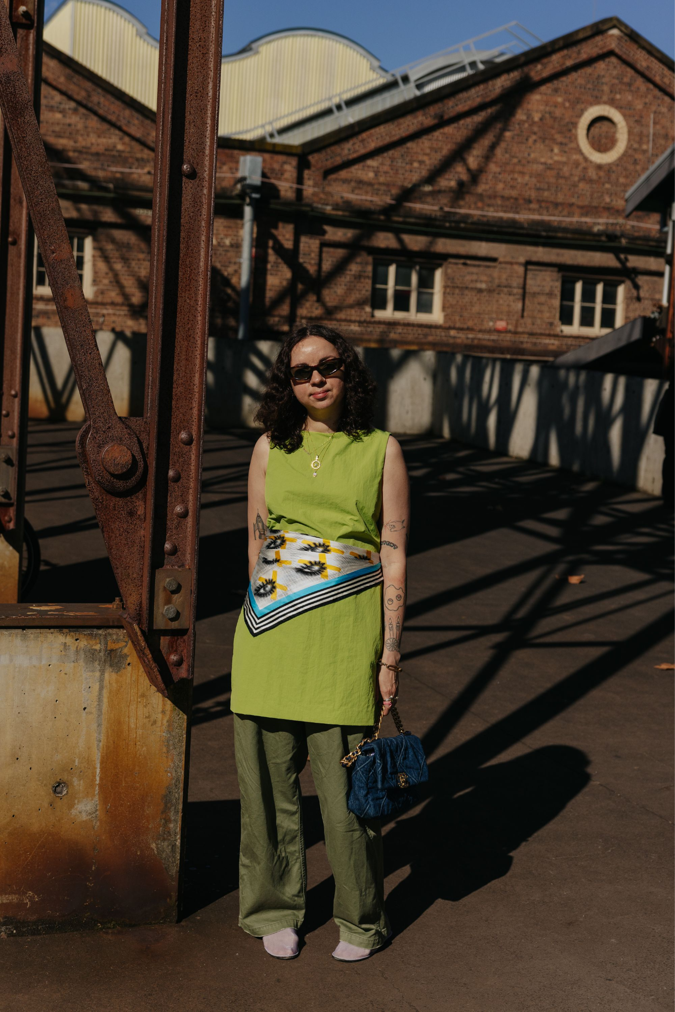 Images may contain clothes pants accessories handbags handbags adult t-shirt sunglasses long sleeves and sleeves