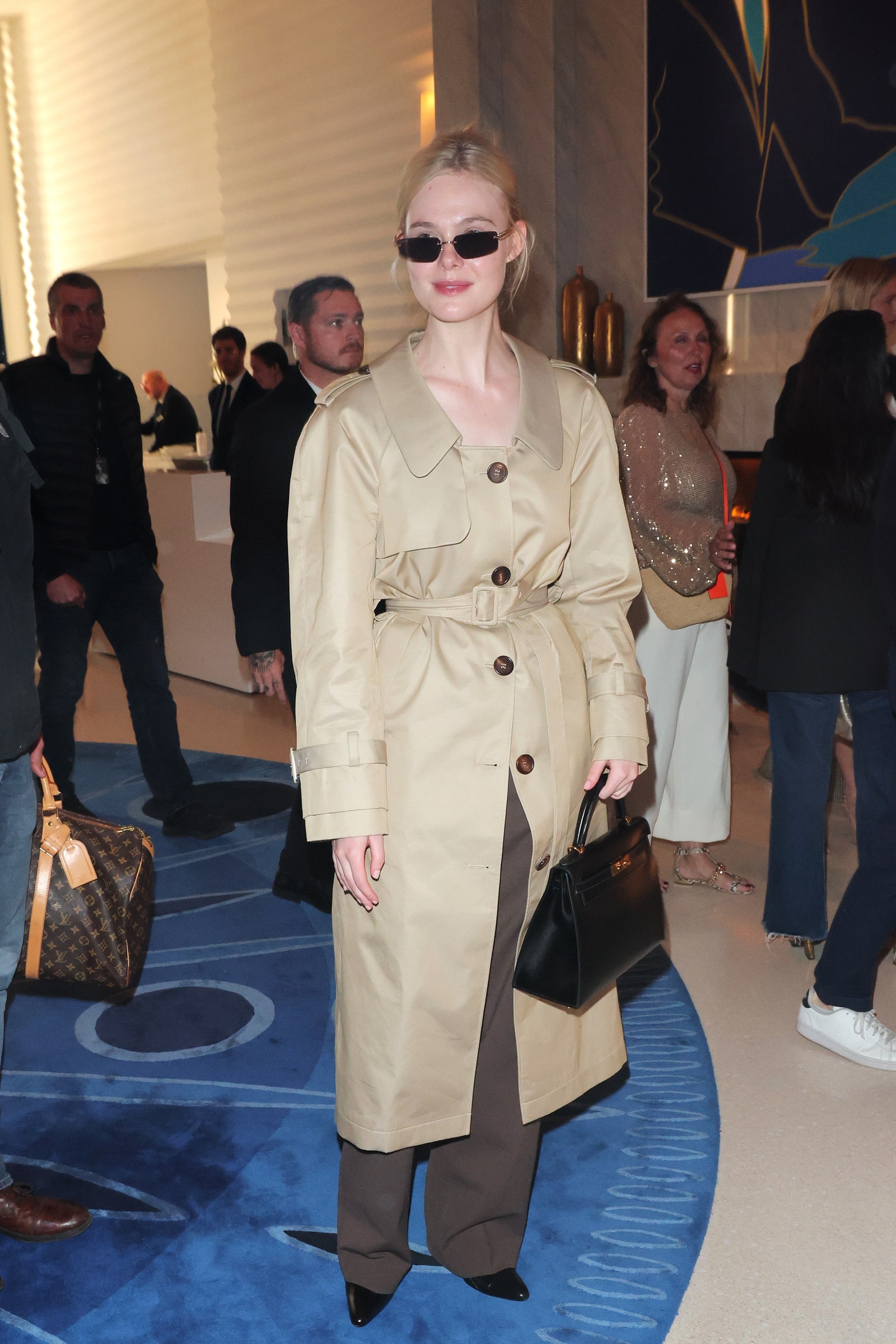 Images may contain Elle Fanning Kate Burton Clothing Shoes Shoes Accessories Tote Bag Handbag Coat and Adults