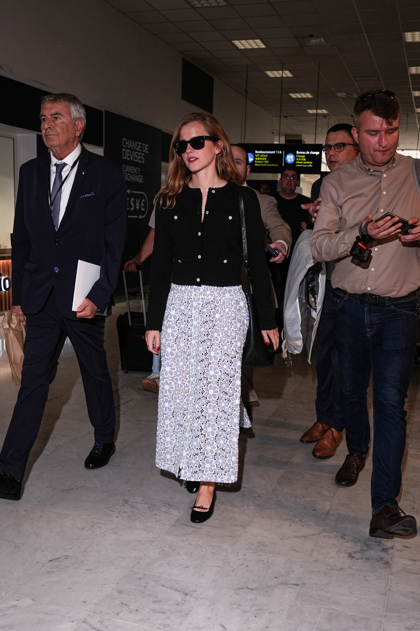 Images may contain Emma Watson clothing shoes shoes accessories glasses handbag handbag formal wear tie and adult