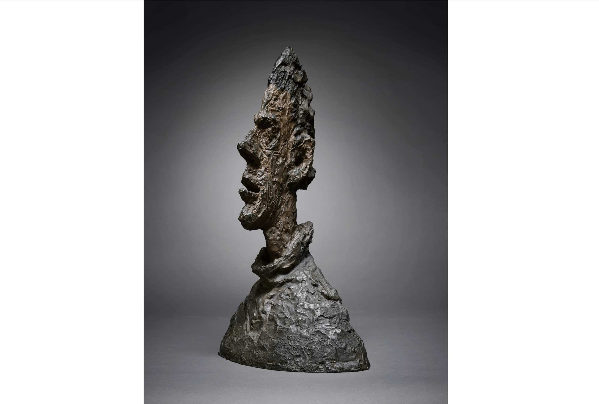 A man's jagged bronze bust.