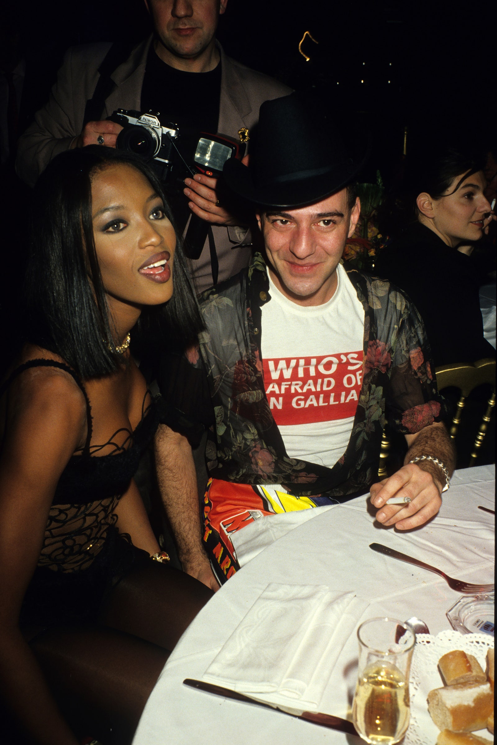 Images may contain Naomi Campbell John Galliano Cutlery Fork Photography Cup Urban Camera Electronics Electronics Face and Head