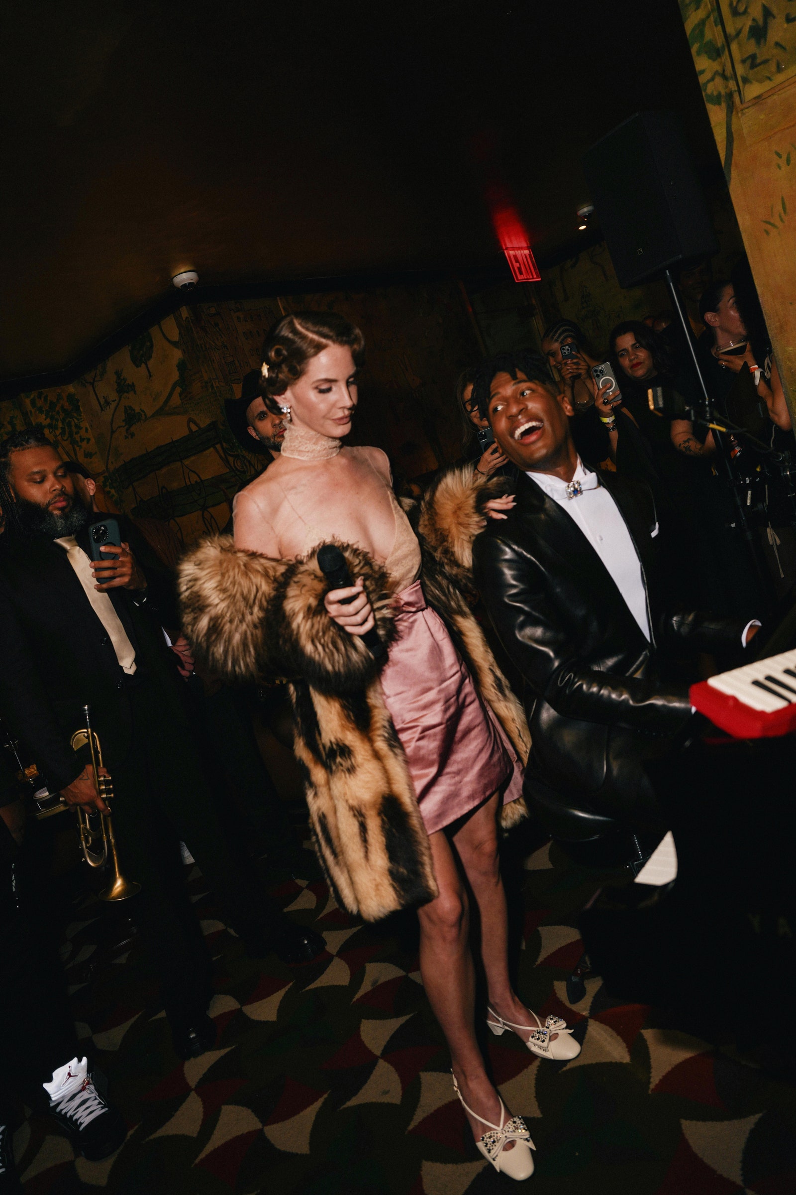 Images may contain Jon Batiste Lana del Rey Joe Joe Saylor blazer formally wearing suit and shoes