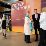 People stand in front of a sign reading New York Fritz.